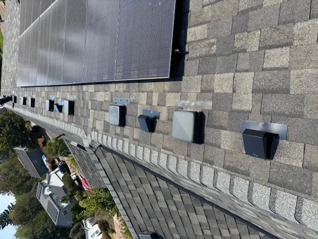 Solar panel mounting hardware installed on composite shingle roof with proper flashing